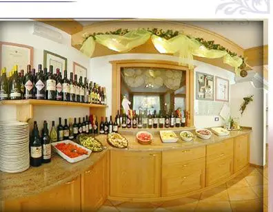a bar with a lot of bottles of wine at Hotel Zanon in Ziano di Fiemme