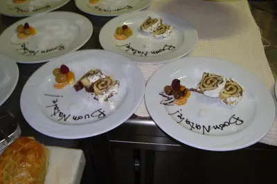 four plates of desserts on a table with happy new years written on them at Hotel Zanon in Ziano di Fiemme