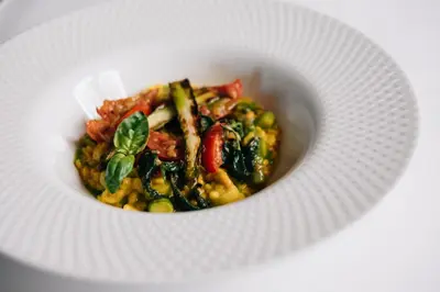 a white bowl of food on a white plate at Hotel Jägerhof in San Leonardo in Passiria