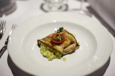 a white plate with food on a table at Hotel Jägerhof in San Leonardo in Passiria