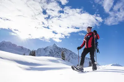a man is standing on skis in the snow at Hotel Jägerhof in San Leonardo in Passiria