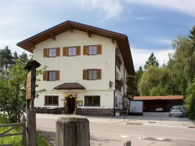 a large white building with a wooden roof at Schönblick OHG des Daum Tobias in Aldino