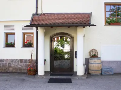 a house with a door and a barrel at Schönblick OHG des Daum Tobias in Aldino