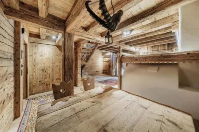 a large room with a wooden table and chairs at Luxury Cortina in Cortina dʼAmpezzo