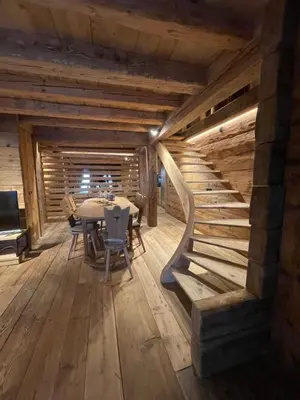 a dining room with a table and a staircase at Luxury Cortina in Cortina dʼAmpezzo