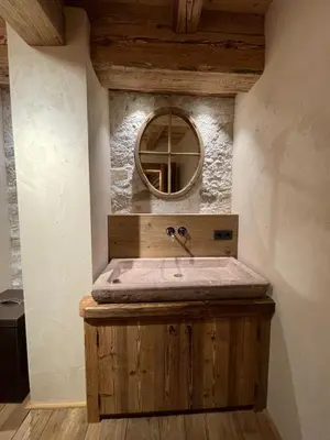 a bathroom with a sink and a mirror at Luxury Cortina in Cortina dʼAmpezzo