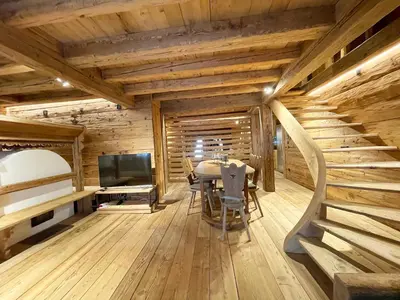 a dining room with a table and a television at Luxury Cortina in Cortina dʼAmpezzo