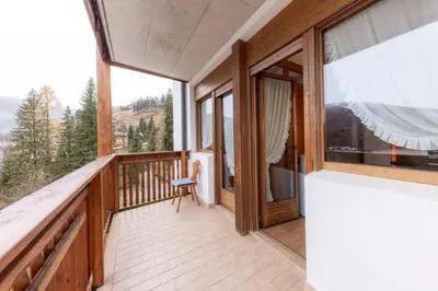 a balcony with a view of the mountains at Ski Residence in San Martino di Castrozza
