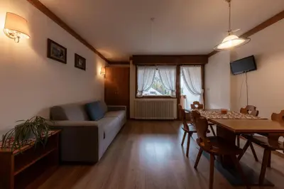 a living room with a couch and a table at Ski Residence in San Martino di Castrozza
