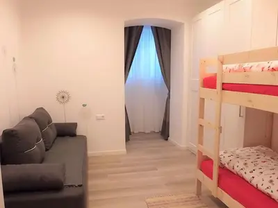 a living room with a couch and a bunk bed at Villa Wally in Merano