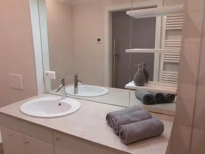 a bathroom with two sinks and a mirror at Villa Wally in Merano