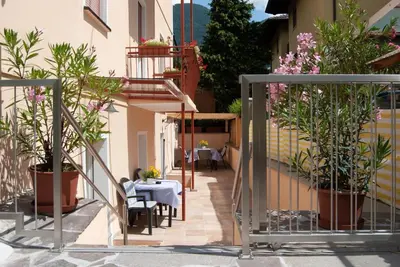 a balcony with plants and a table and chairs at Villa Wally in Merano