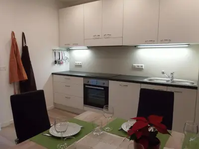 a kitchen with a table with wine glasses on it at Villa Wally in Merano