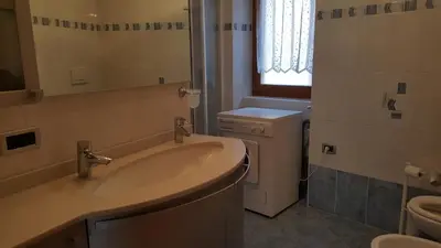 a bathroom with a sink and a toilet at Casa Bedovina in Predazzo