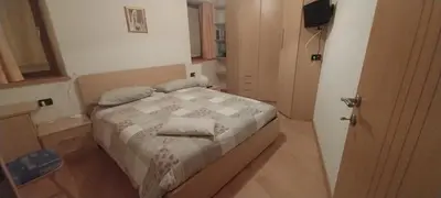 a bedroom with a bed with two pillows on it at Casa Bedovina in Predazzo