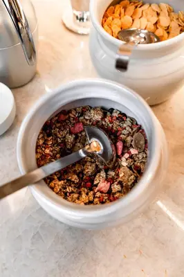 a bowl of food with a spoon in it on a table at Hotel Garni Günther in Postal