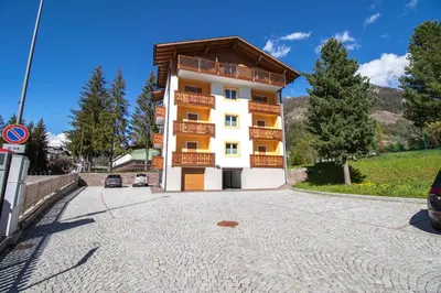 a building with balconies on the side of a road at Casa Ciroch in Moena