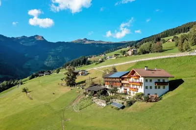a house on a hill in a green field at Thalhofer Hof in Lazfons