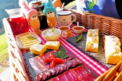 a picnic basket with cheese and meats and other foods at Thalhofer Hof in Lazfons