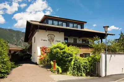 a house with a pathway leading up to it at Bed&Breakfast Pension Hilpold in Lana