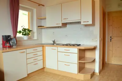 a kitchen with white cabinets and a sink at Haus Hofer in Barbiano