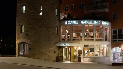 a hotel building with a hotel goldeneye sign on it at Hotel Goldene Rose in Brunico