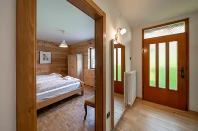 a bedroom with a bed and a sliding door at Casa del Salice in Carano