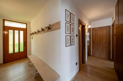a living room with a bench on a wall at Casa del Salice in Carano