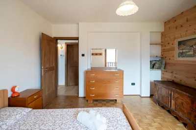 a bedroom with a bed and a dresser and a mirror at Casa del Salice in Carano
