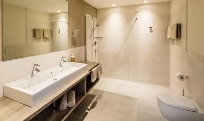 a bathroom with a sink and a shower and a toilet at Rösslwirt in Barbiano
