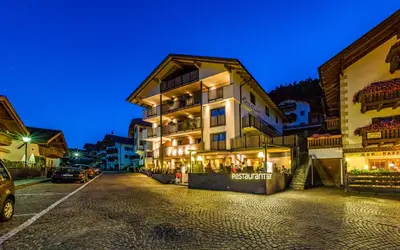 a building on a street at night at Rösslwirt in Barbiano