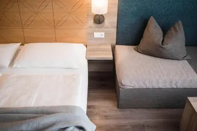 a bedroom with two beds with pillows on them at Rösslwirt in Barbiano