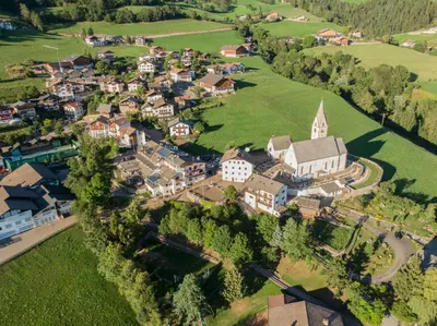 an aerial view of a small town with a church at Hotel Zum Löwen - Al Leone in Meltina