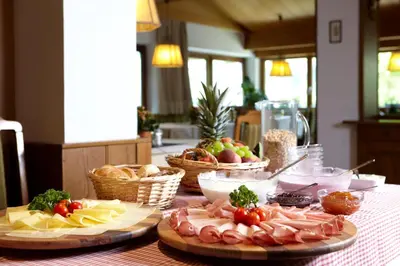 a table topped with plates of food on a table at Hotel Zum Löwen - Al Leone in Meltina