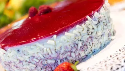 a red white and blue cake with strawberries on a plate at Activehotel Diana in Siusi