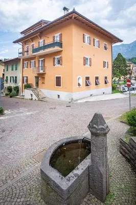 a water fountain in front of a building at Holiday Apartments Val Moena 1 in Cavalese