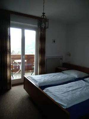 a bedroom with a bed and a large window at Mühlhaus in Schenna