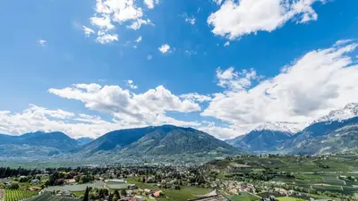 a town in a valley with mountains in the background at Schenna Resort in Schenna