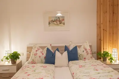 a bedroom with a bed with blue and white pillows at Schlossblick in Vols am Schlern