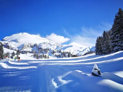 a snow covered mountain with people in the distance at Schlossblick in Vols am Schlern