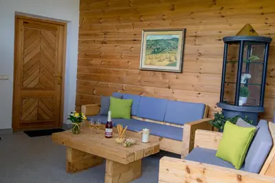 a room with a couch and a table and a door at Schlossblick in Vols am Schlern