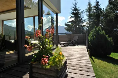 a porch with flowers in a wooden box at The Vista Hotel in Bressanone
