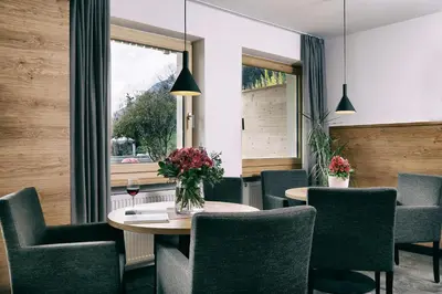 a dining room with a table and chairs and a window at Garni Oberanger in Tirolo