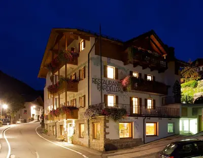 a building on a street at night at Hotel B&B Pardeller in Nova Levante