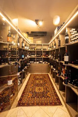a room filled with lots of bottles of wine at Hotel Finkenhof - Feel at home in Schenna