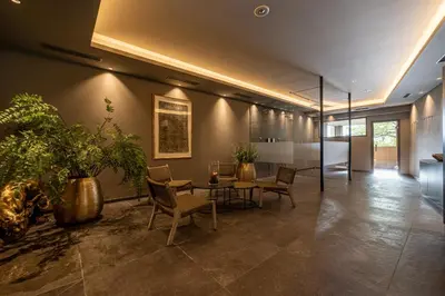 an office with a table and chairs and plants at Hotel Finkenhof - Feel at home in Schenna