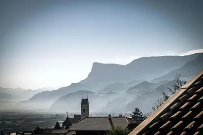 a view of a town with mountains in the background at Landhaus Hotel Kristall in Marlengo
