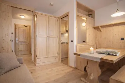 a living room with a table and a couch at Sporting Aparthotel in San Martino di Castrozza
