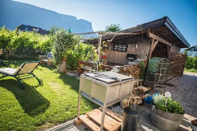 a garden with a house with a stove in it at Lochererhof in Appiano sulla Strada del Vino