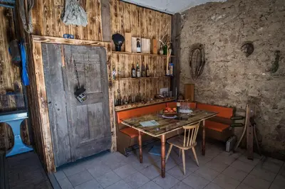 a dining room with a table and a wooden door at Lochererhof in Appiano sulla Strada del Vino